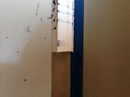 image: Sorry. Can't figure out how to rotate photo. The blue is the cutting stick and the paper is being clamped down. Notice the crop mark on left edge gradually disappear.